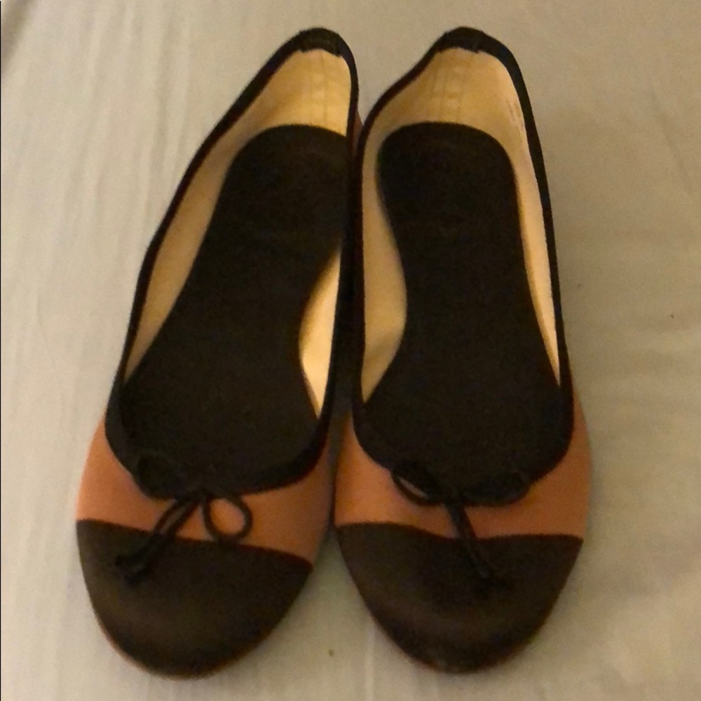 Worn J. Crew tan and black flats.